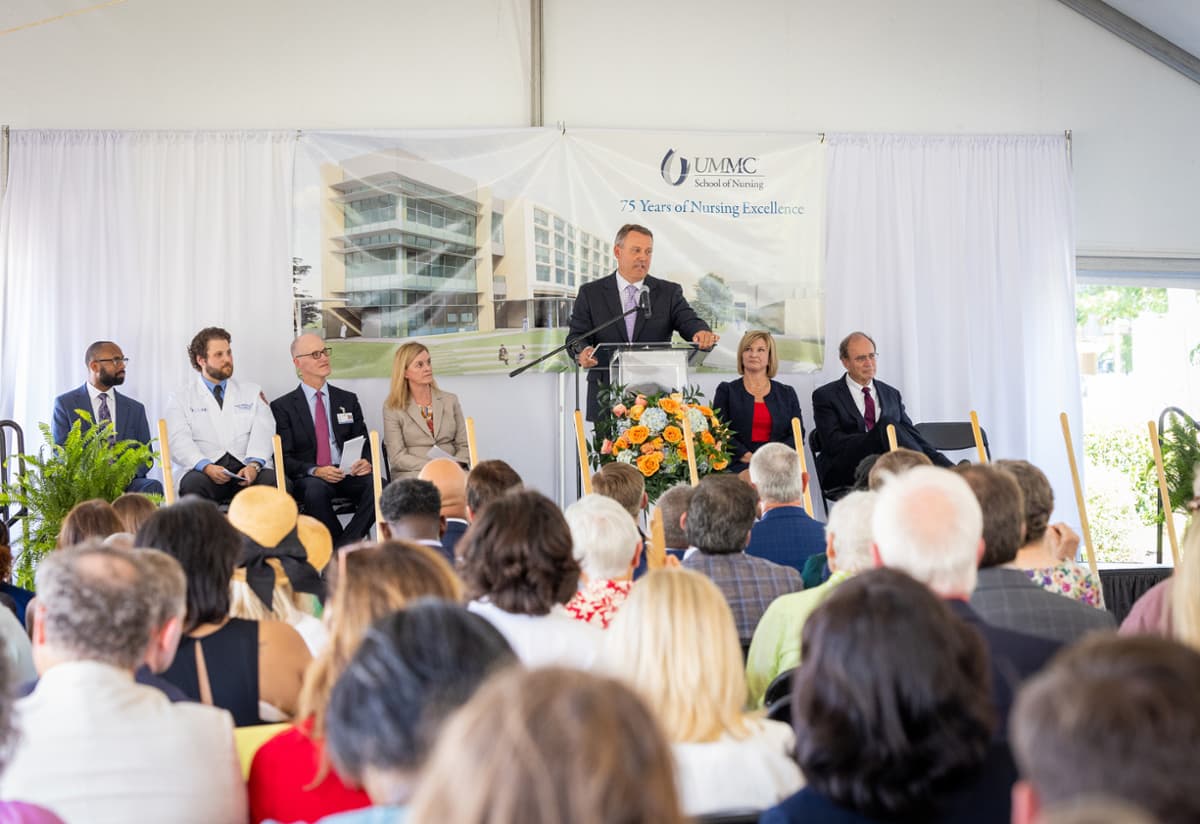 Representative Jason White speaks at the new UMMC School of Nursing Groundbreaking ceremony before he and others shovel out sand signifying ground breaking